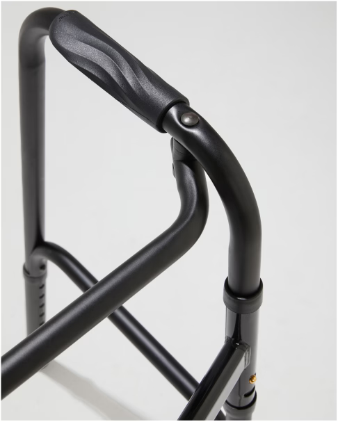 Close-up of a black walker frame on a light gray background