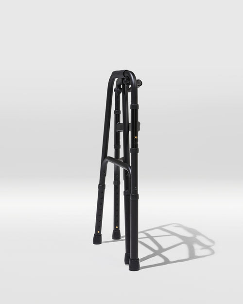 Black adjustable tripod on a white background