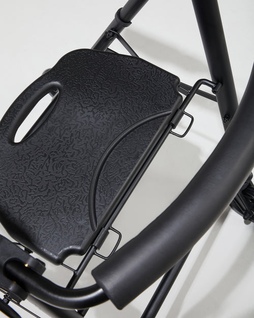 Close-up of a black bike seat and handlebar on a white background