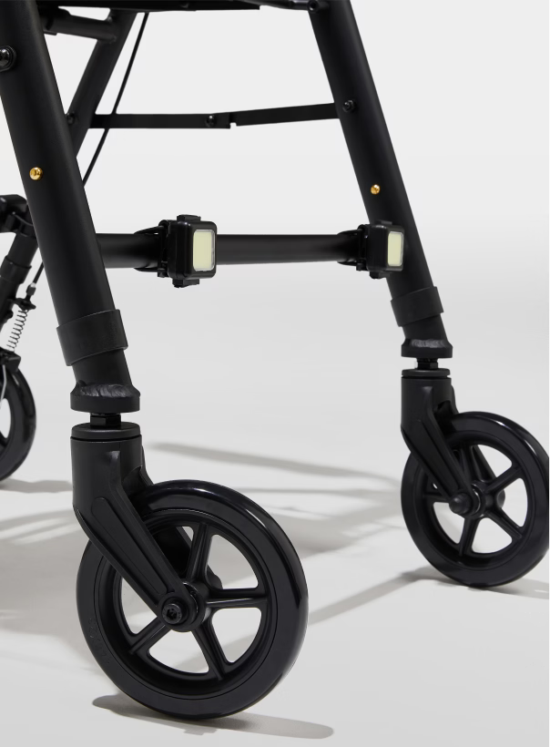 Close-up of a black walker with wheels on a white background