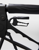Close-up of a black archery bow with a white background
