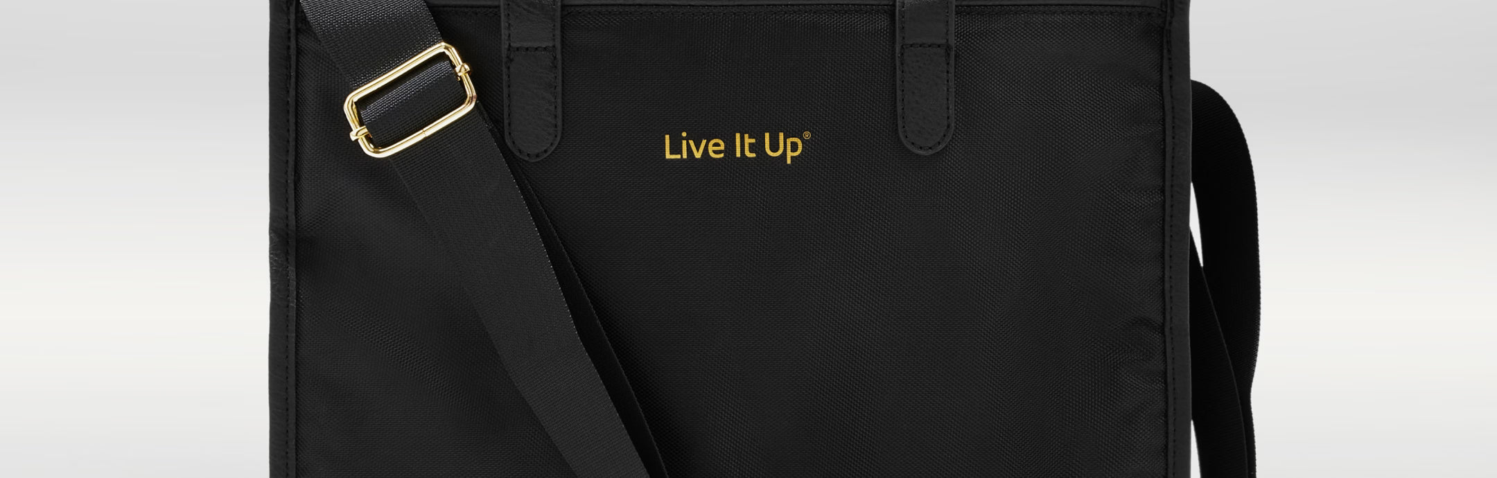 Black bag with 'Live It Up' text on a light gray background