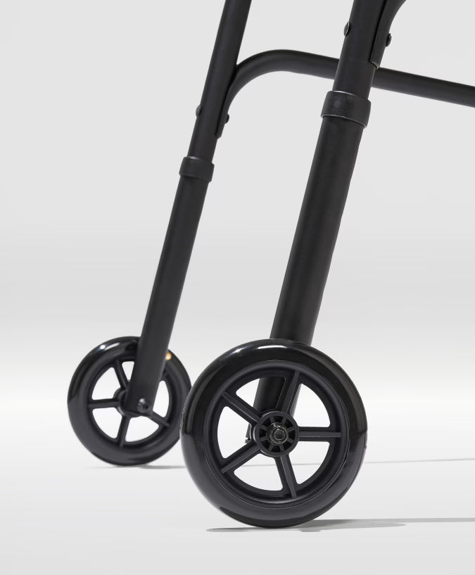 Close-up of a black walker with wheels on a white background