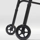Close-up of a black walker with wheels on a white background
