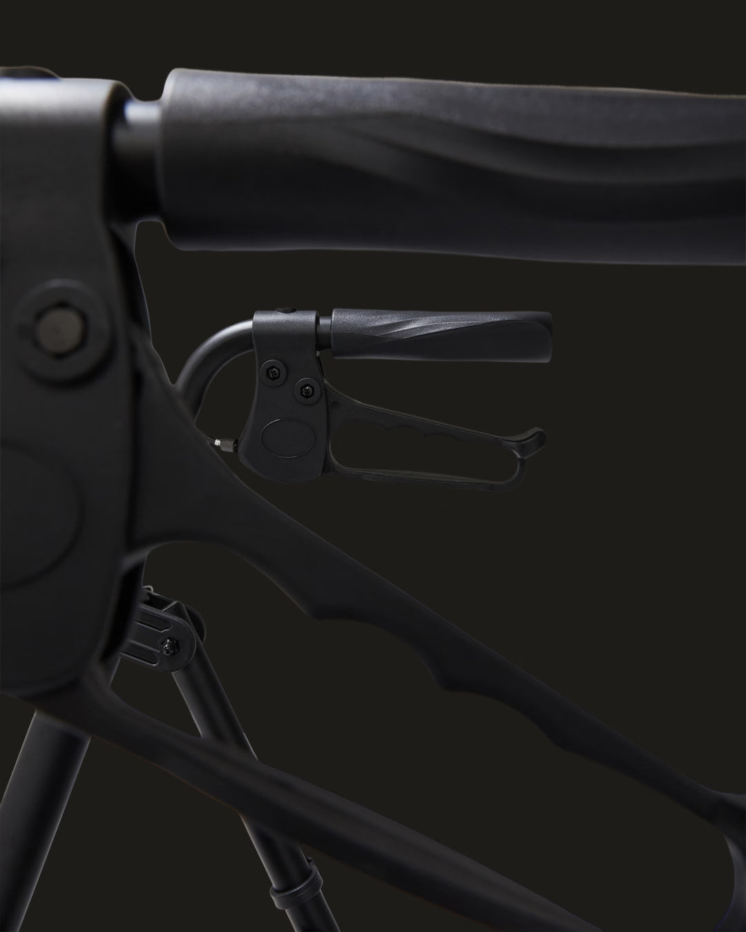 Close-up of a black metal clamp on a dark background